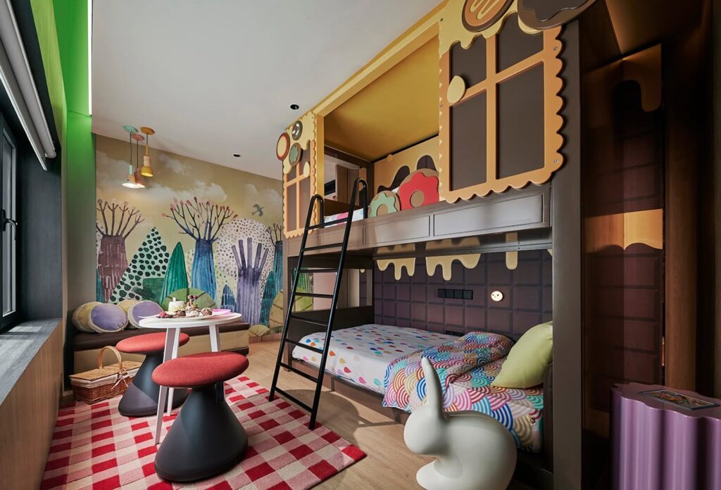 PARKROYAL Collection Kuala Lumpur themed family suite featuring colorful themed bunk beds, kids' play corner with toys, and separate bedroom areas