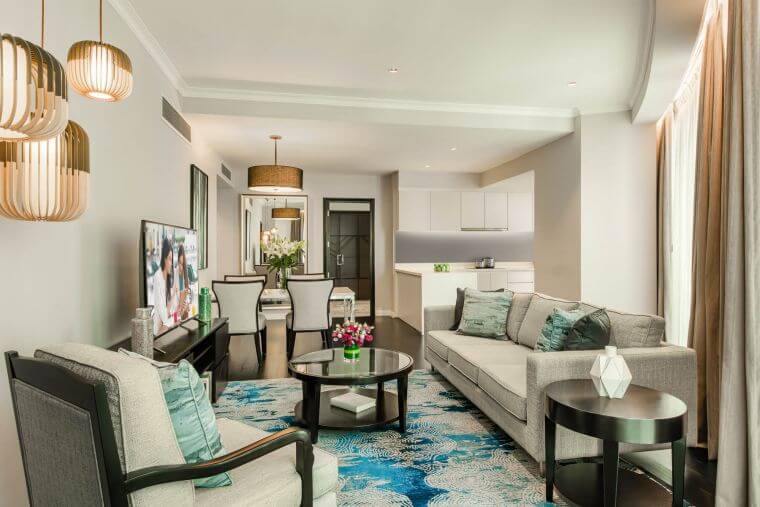 Ascott Kuala Lumpur two-bedroom serviced apartment showing spacious living room, modern kitchen facilities, dining area, and family-friendly amenities