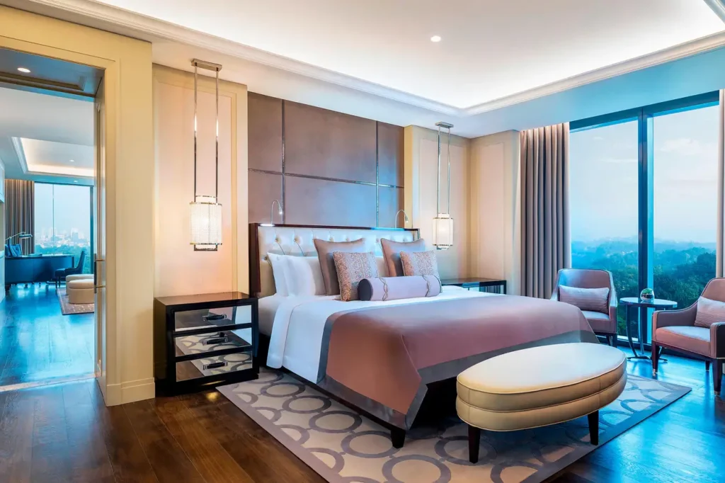St. Regis Kuala Lumpur spacious family suite with sophisticated decor, large windows overlooking city skyline, elegant furniture, and Christmas holiday decorations