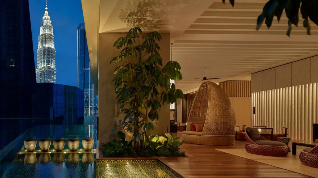 The RuMa Hotel infinity pool on sixth floor with stunning Kuala Lumpur skyline views, contemporary design, and adjacent children's pool area