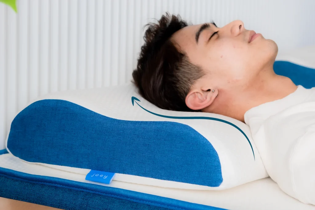 guys head on Joey Pillow while laying on a bed